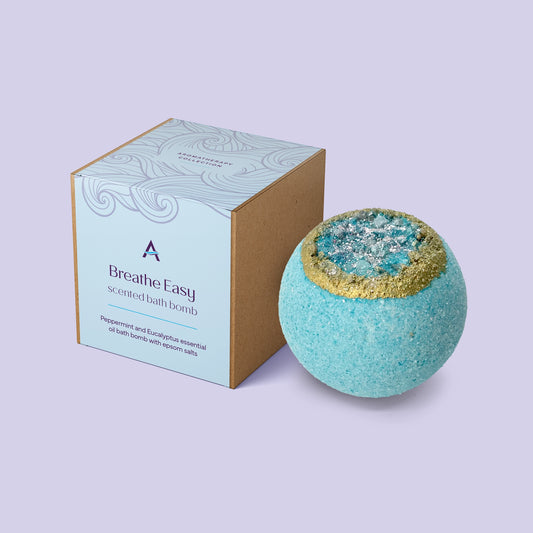 Breathe Easy bath bomb with peppermint, eucalyptus, and lavender essential oils, enriched with cocoa butter, coconut milk, kaolin clay, and Epsom salts for a clearing, soothing bath experience.