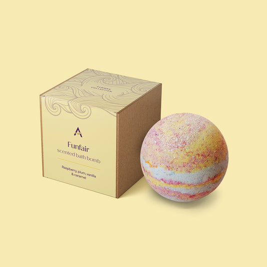 Funfair bath bomb with blue, pink and yellow pastel swirls, biodegradable silver shimmer and fragranced with raspberry, plum, vanilla and caramel.