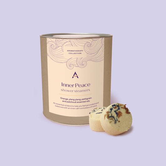 Grounding aromatherapy shower steamers with sweet orange, frankincense and cedarwood in eco-friendly canister.