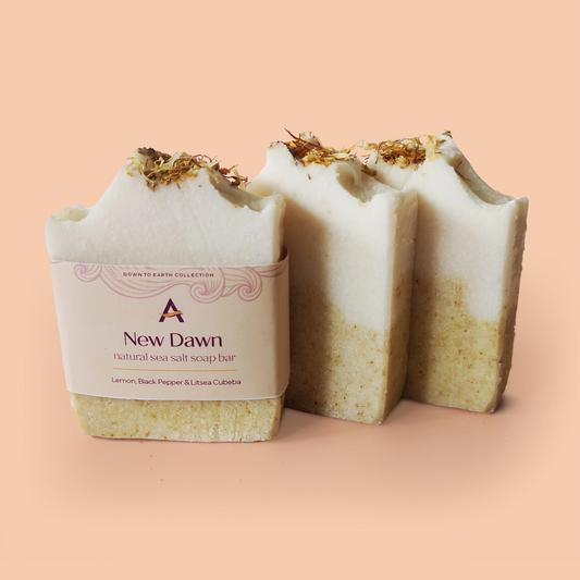 three solid white and yellow soap bars, one with a label