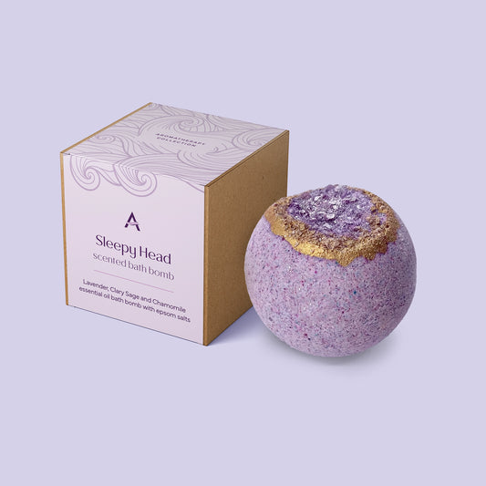 Sleepy Head bath bomb with calming lavender, chamomile and clary sage essential oils, enriched with with coconut milk, kaolin clay, cocoa butter and Epsom salts for a relaxing soak.
