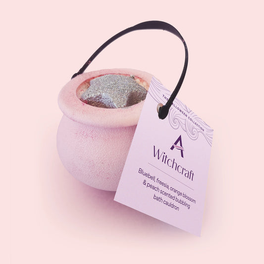A pink and purple Witchcraft Bubbling Bath Cauldron with a star-shaped decoration on the top.