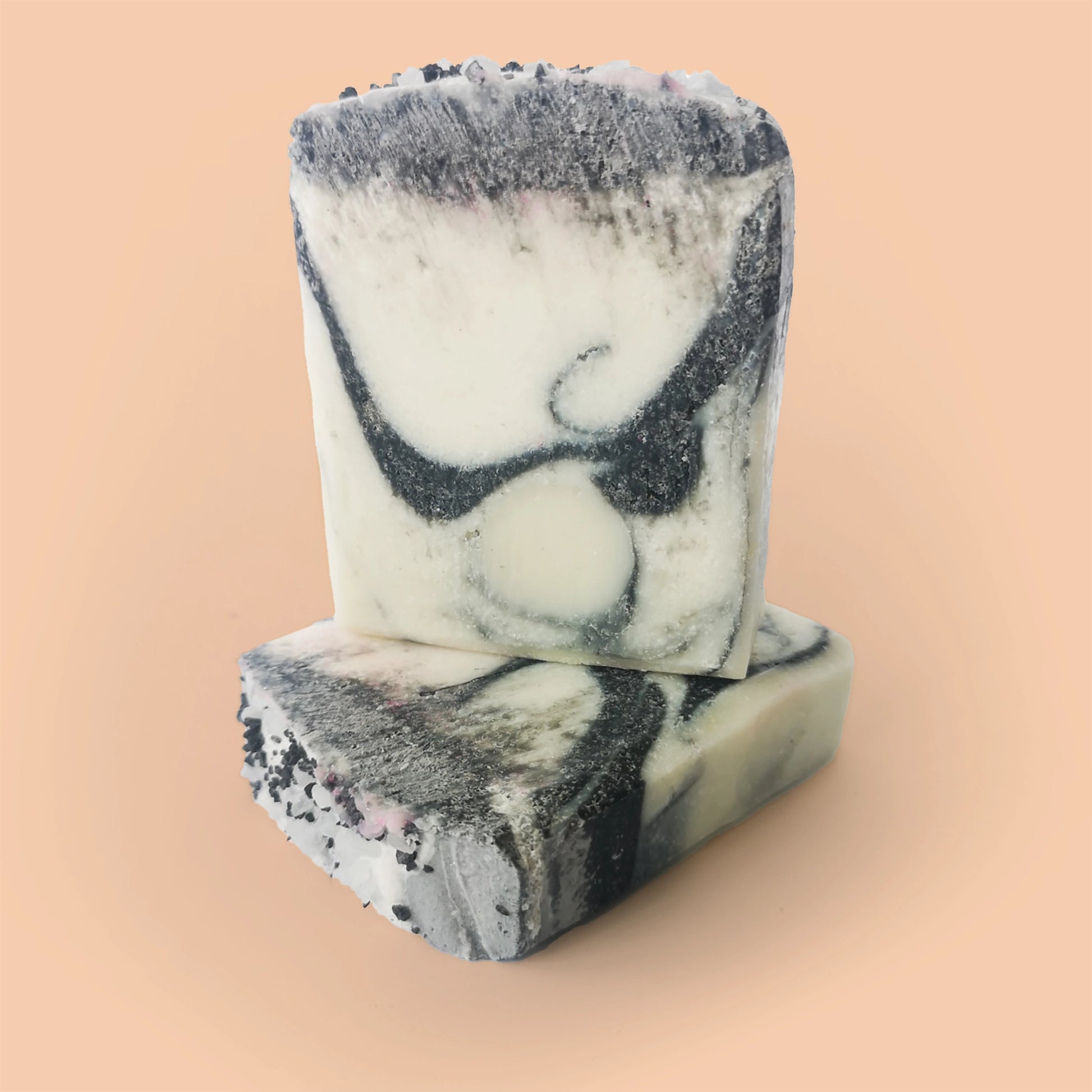 stack of three black and white soaps unlabelled.