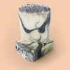 stack of three black and white soaps unlabelled.