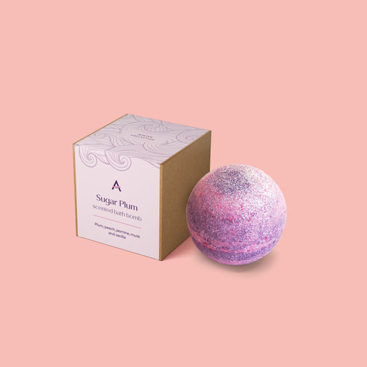 Vegan sugar plum bath bomb with pink and lilac pastel colours and eco glitter
