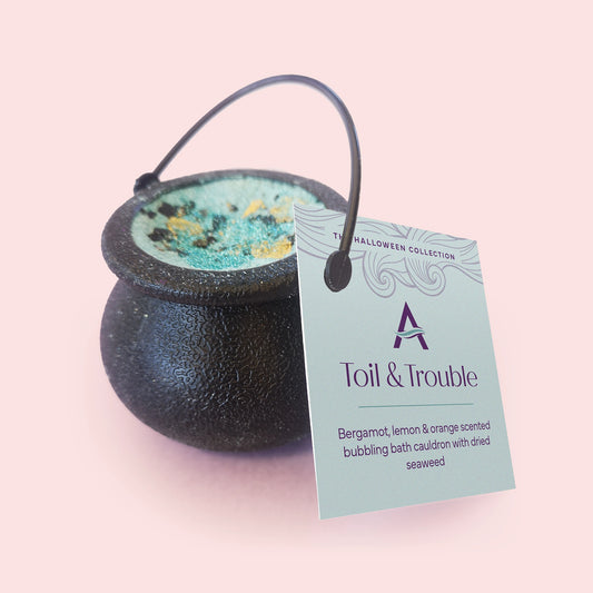 black cauldron with teal coloured bath bomb mix inside